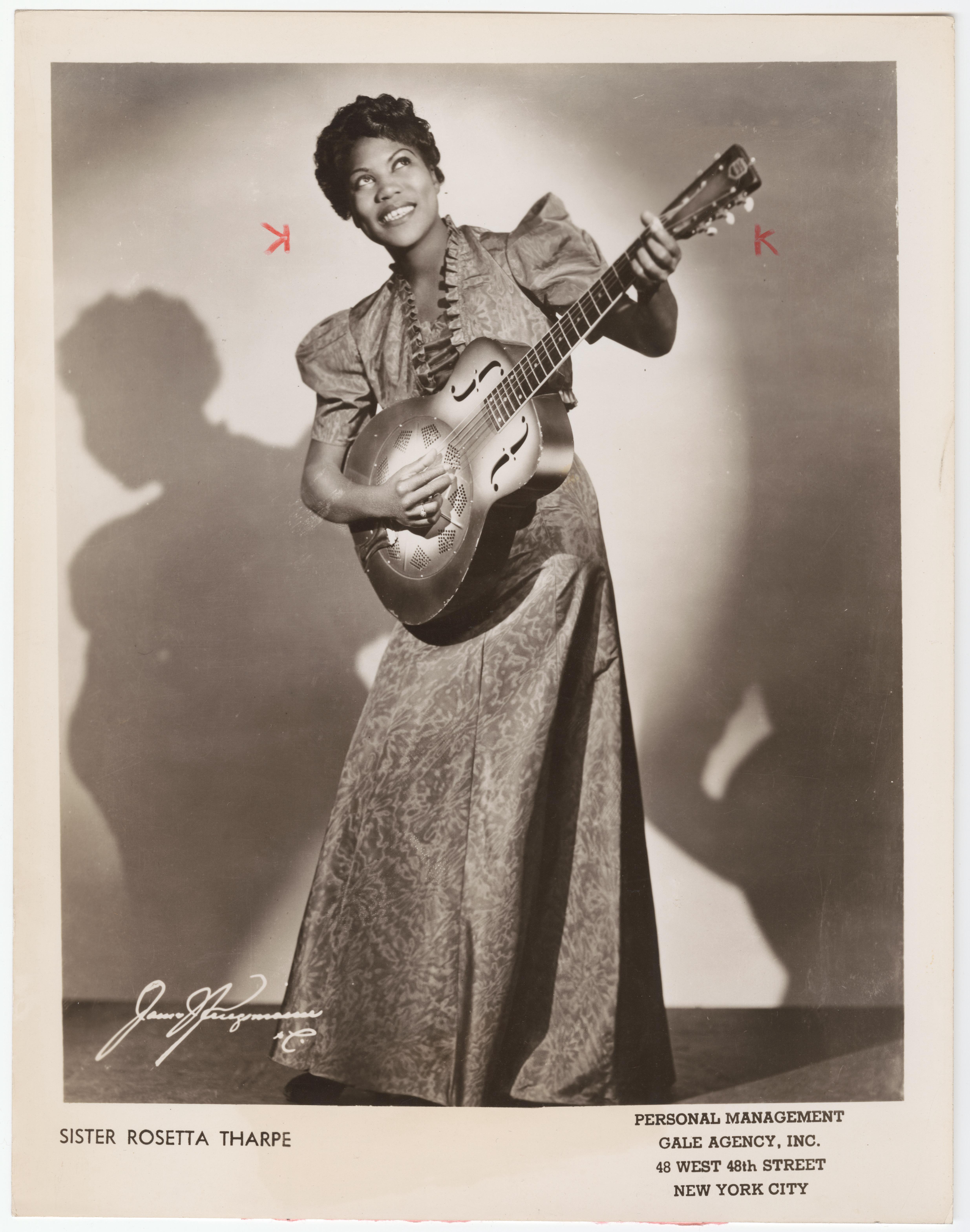Untrimmed promotional image of Sister Rosetta Tharpe with guitar.