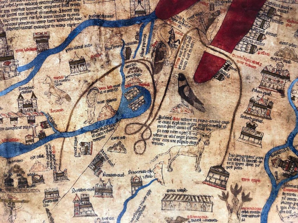 Detail of the Red Sea on the Hereford Mappa Mundi. The Red Sea is drawn with red ink and is bisected at one side by a brown path that shows the wandering of the H