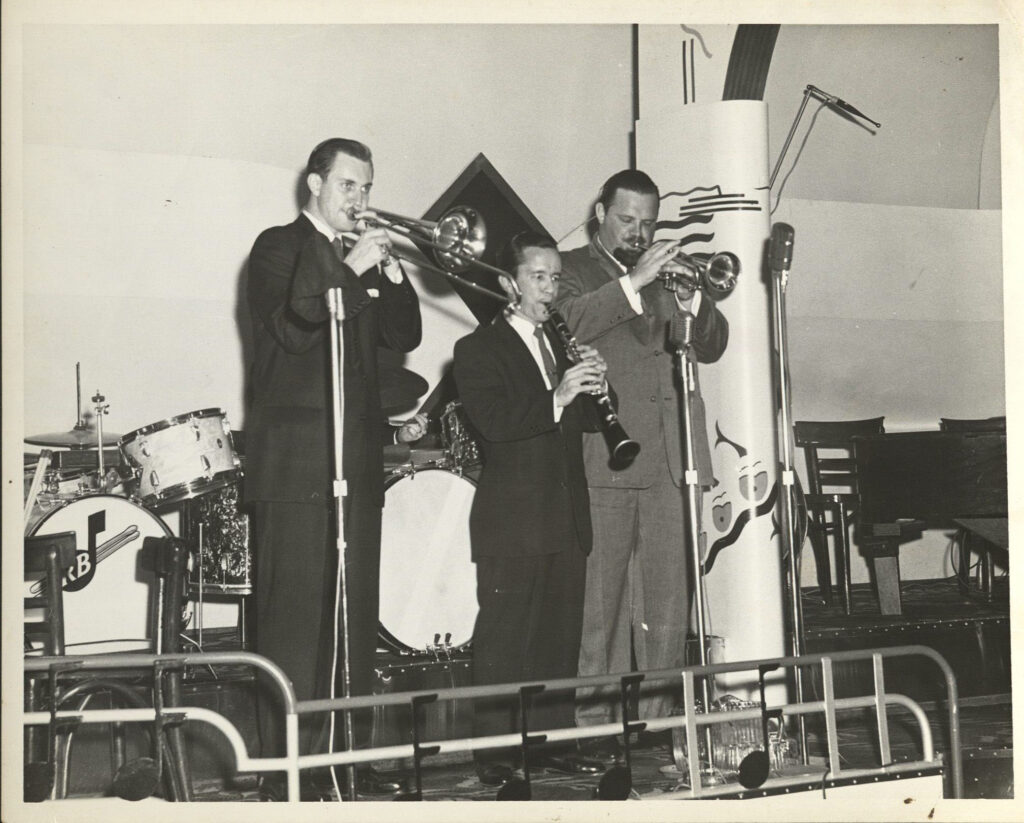 L. to r.: Bob Havens, trombone; Harold Cooper, clarinet; and Al Hirt, trumpet, perform during Jazz Fest’s Steamboat Stomp evening concert on the Steamer President riverboat, April 18, 1974, photographer: Jerry Bray, Mina Lea Crais collection HJA-060, 117.103, Tulane University Special Collections.