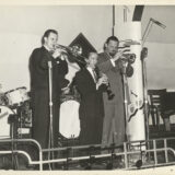 L. to r.: Bob Havens, trombone; Harold Cooper, clarinet; and Al Hirt, trumpet, perform during Jazz Fest’s Steamboat Stomp evening concert on the Steamer President riverboat, April 18, 1974, photographer: Jerry Bray, Mina Lea Crais collection HJA-060, 117.103, Tulane University Special Collections.