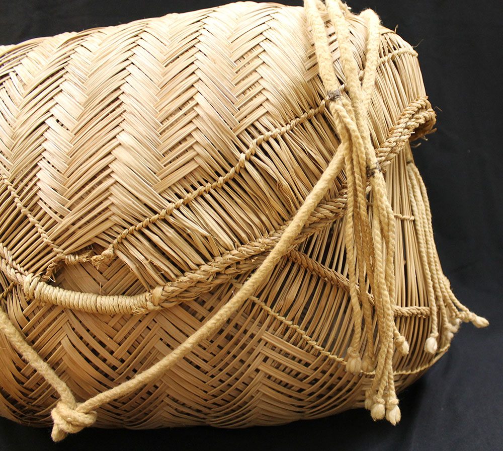 Close- up of Xavante basket with braided strap and lid