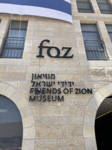 An outdoor sign of the Friends of Zion Museum which reads FOZ friends of zion