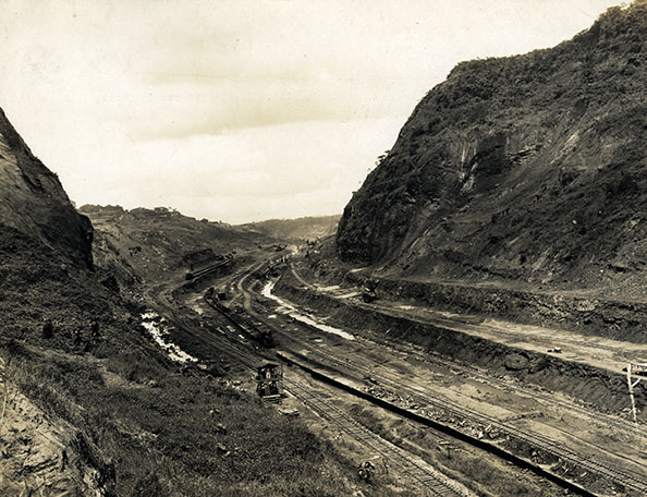 Train tracks cut through a mountain range.