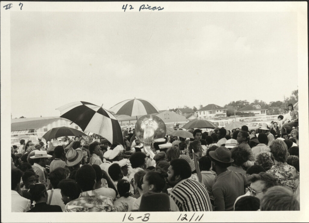 Crowd surrounds brass band at Jazz Fest, undated circa 1970s, photographer: Jay Andersen, Mina Lea Crais collection HJA-060, 117.095, Tulane University Special Collections.