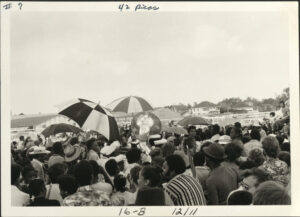 Crowd surrounds brass band at Jazz Fest, undated circa 1970s, photographer: Jay Andersen, Mina Lea Crais collection HJA-060, 117.095, Tulane University Special Collections.