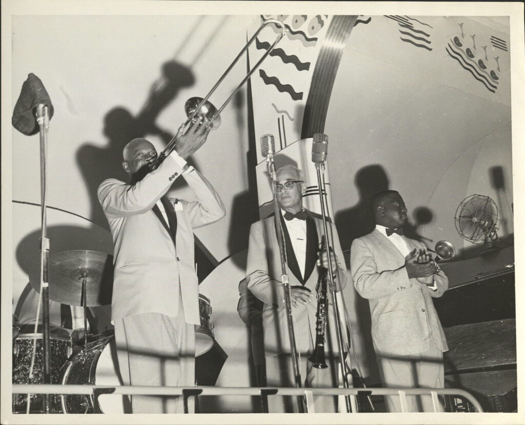 L. to r.: Bill Matthews, trombone; Albert Burbank, clarinet; and Wallace Davenport, trumpet, perform during Jazz Fest’s Steamboat Stomp evening concert on the Steamer President riverboat, April 18, 1974, photographer: Jerry Bray, Mina Lea Crais collection HJA-060, 117.106, Tulane University Special Collections.