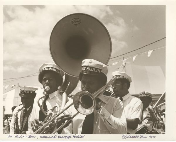 Doc Paulin’s Band performs at Jazz Fest, l. to r.: unidentified tenor saxophonist; Dwayne Paulin, sousaphone; Darryl Walker, trombone; Doc Paulin, trumpet; Michael White, clarinet; and Ricky Paulin, snare drum; 1977, photographer: Harriet Blum, Hogan Archive Photography Collection, PH003243, Tulane University Special Collections.