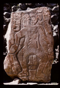 Carved rock sculpture of a dancing figure