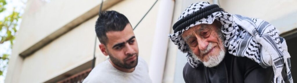 An older man looking sad while the younger man looks concerned